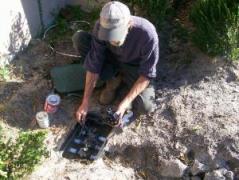 a tech checks a valve control box